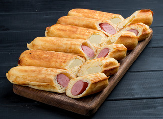Home made corn dogs, on a dark wooden background. Classic american food