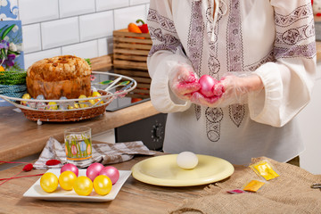 Person paint a egg made of polystyrene. Colorized acrylic egg