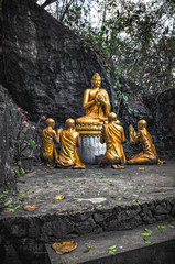 Statue of the Buddha and his disciples on the way up Mount Phusi in Luang Prabang, Laos
