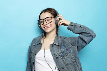 Beautiful young woman listening to music in headphones  