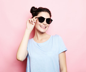 brunette girl with hairbuns wearing sunglasses