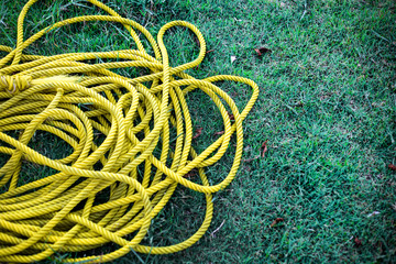 yellow nylon rope on green grass