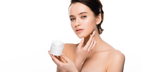 panoramic shot of pretty woman holding container with cosmetic cream and looking at camera isolated on white