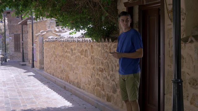 Young man comes out the wooden door