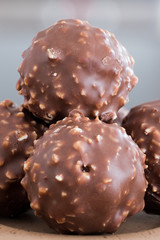 Chocolate & Crushed Almond Crispy Balls on a Light Brown Serving Plate and in Natural Light