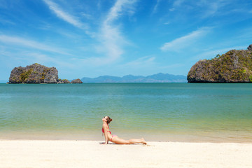 Fototapeta na wymiar Young woman practice yoga on a beach
