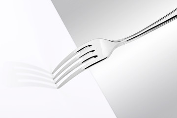 Fork in high key with bright setting on white table