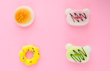fake donuts on a pink isolated background. For background lettering