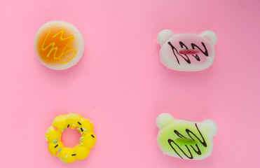 fake donuts on a pink isolated background. For background lettering