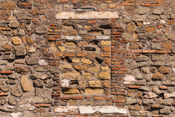 Closed window on old compositre wall with rough surface as background