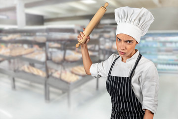 Menacing chef with a rolling pin, Angry cook threatening if you enter her kitchen