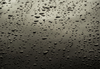 Water drops on dark metal surface. Abstract background