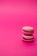 Two macarons on magenta background