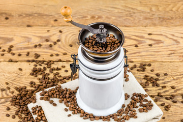 Vintage coffee grinder mill with coffee beans.
