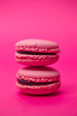 Two macarons on magenta background