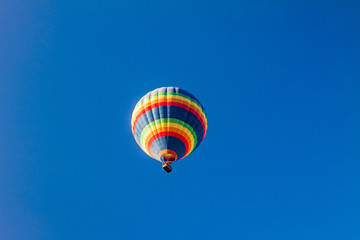 Colorful hot air balloons over blue sky.