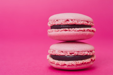 Two macarons on magenta background
