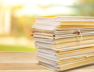 File folders with documents isolated on white