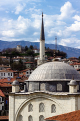Fototapeta na wymiar Vertical shoot of old masonry stone town mosque with copper dome in Safranbolu