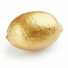 Golden lemon on white