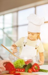 Portrait of adorable little girl preparing healthy