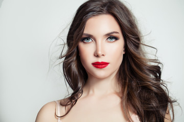 Fototapeta premium Stylish brunette model portrait. Beautiful woman with long curly hair and makeup on white background