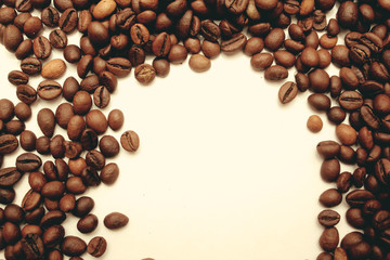 frame of coffee beans with space for text. view from above. coffee beans on a white background.