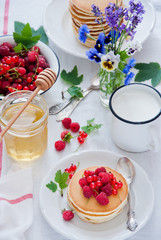 Homemade Pancakes with fresh red berries and honey