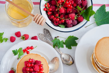 Homemade Pancakes with fresh red berries and honey