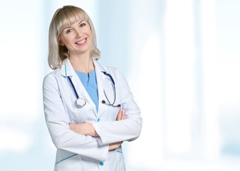 Male doctor with stethoscope on blurred hospital