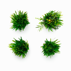 Artificial grassy plants in pots isolated on white