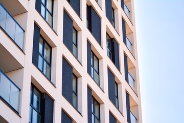 Modern apartment buildings on a sunny day with a blue sky. Facade of a modern apartment building