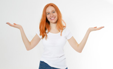 Smile beautiful red head girl show copy space hand in white t-shirt isolated on white background. Showing redhair woman - two hands empty for product or text. Casual woman model smiling happy.