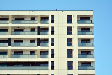 Fototapeta premium Modern apartment buildings on a sunny day with a blue sky. Facade of a modern apartment building