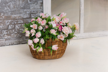 Fototapeta na wymiar Artificial flowers in a basket