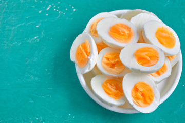 Sliced hard boiled eggs on color background  Nutrition concept