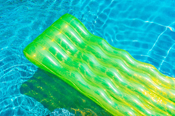 Colorful swim ring or rubber float around swimming pool water