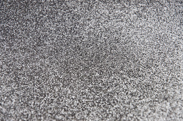 Silver shiny glitter background. Abstract texture for any holiday. Selective focus.