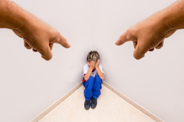 Boy alone being accused by an adult hand. Concept of scolding or punishment. Image about fear and...