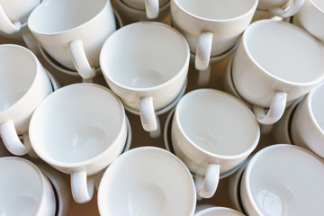 Row of clean plates for soup and first dishes on the table.