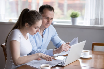 Millennial couple studying contract for new house before signing