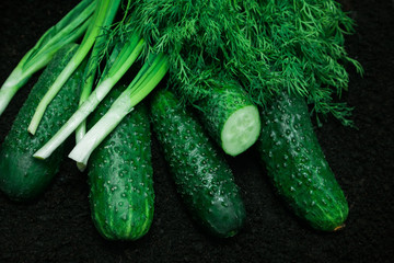 vegetable cucumbers onion parsley ground black background ripe mature green greens several salad