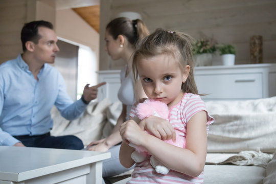 Sad little girl scared when parents have fight at home