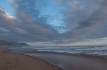 Fototapeta na wymiar The sandy beach at Brenton on Sea, photographed at dusk. Knysna, South Africa.