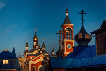 The setting sun is beautifully reflected in the gilding of church crosses
