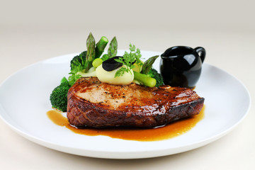 Beef steak with steamed vegetables close up.