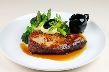 Beef steak with steamed vegetables close up.