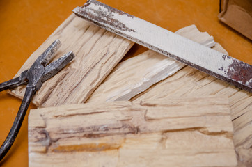 Decorative ceramic tiles, pliers, square, sandpaper close-up