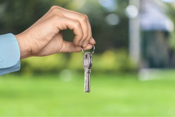 Businessman Holding House Model and Keys, Real Estate Concept