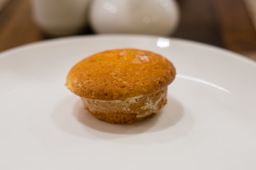 Tasty muffin on white plate.